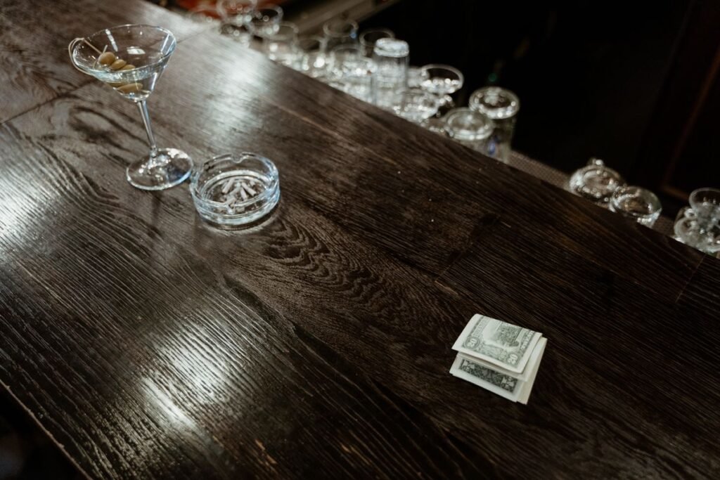 Cash left on a restaurant table after checking the bill for an included service charge