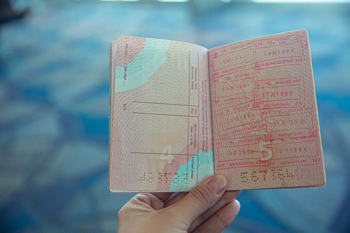 Open passport showing travel stamps at the airport