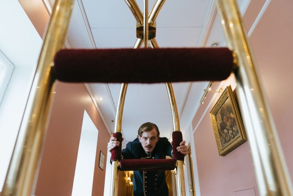 Hotel porter pushing a luggage trolley, one of the services travelers may consider tipping for