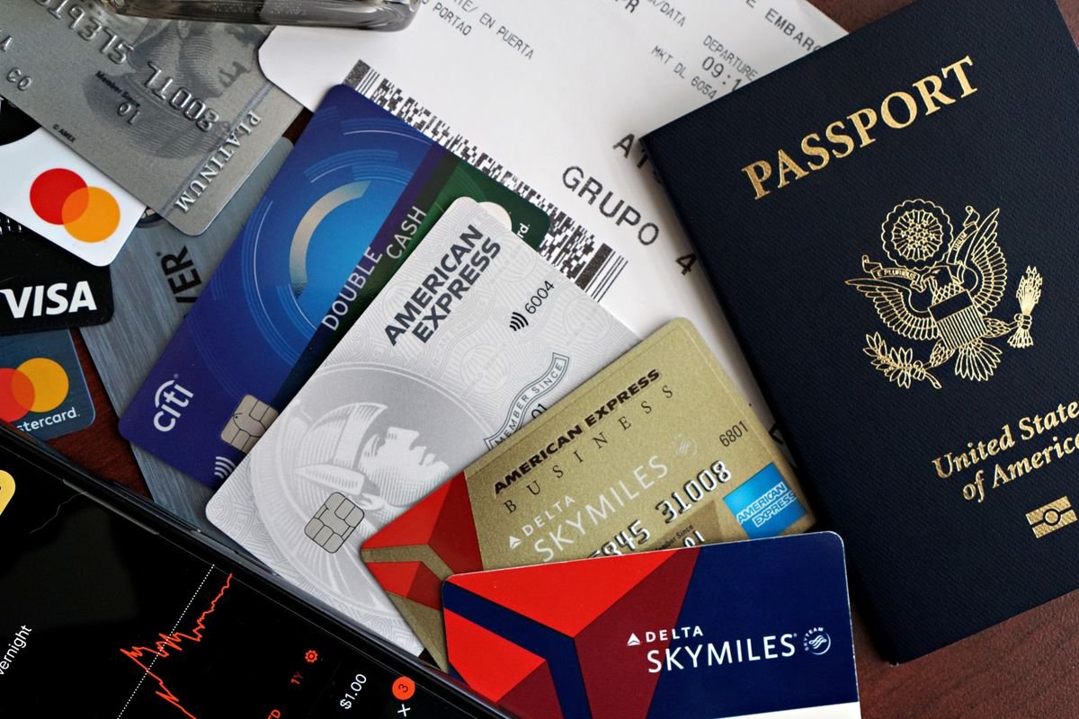 Passport, credit cards, and boarding pass laid out together for a trip