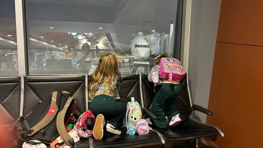 Two granddaughters watching the airplane before flying to Hilton Head
