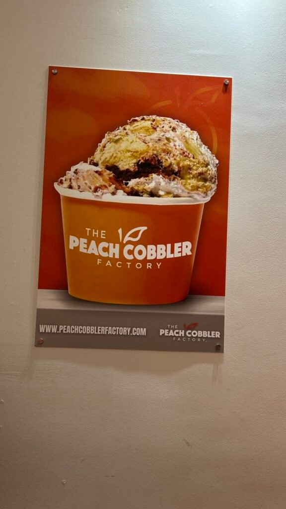 The Peach Cobbler Factory dessert sign